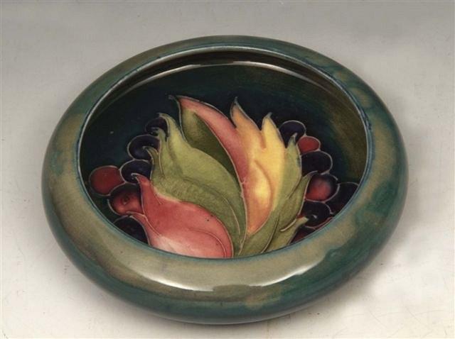 Appraisal: A MOORCROFT 'LEAF AND BERRY' ASH TRAY on green and