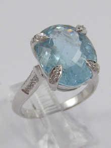 Appraisal: A white metal tests carat gold aquamarine ring with diamond