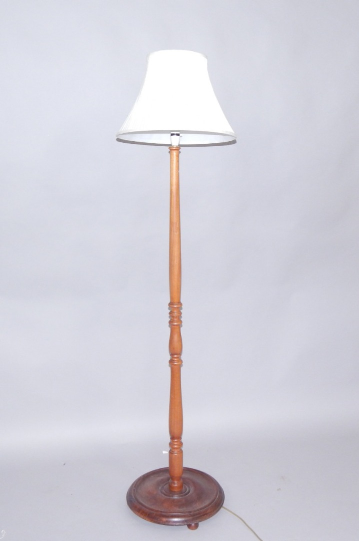 Appraisal: A turned oak standard lamp raised on a circular base