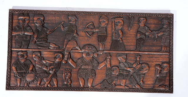 Appraisal: A SOUTH AMERICAN CARVED WOODEN RECTANGULAR PANEL depicting a battle