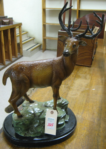 Appraisal: POLYCHROMED BRONZE WILDLIFE SCULPTURE a bull elk standing on rocky