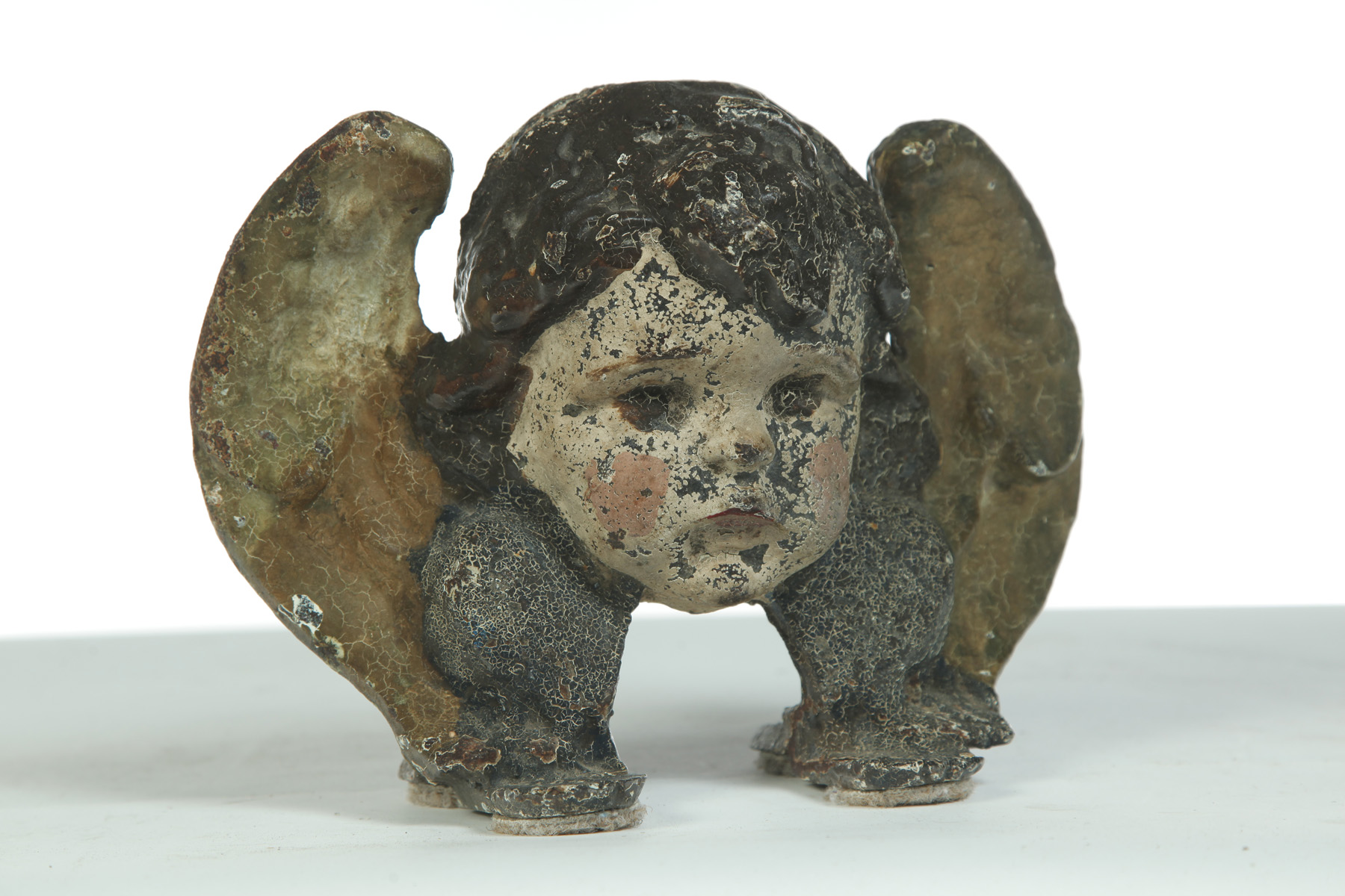 Appraisal: CAST IRON CHERUBS HEAD DOORSTOP American st quarter- th century