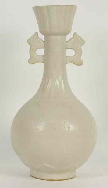 Appraisal: A Chinese white glazed bottle vase incised with calligraphy and