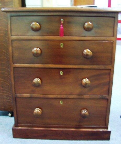 Appraisal: A Victorian chest of four long graduated drawers on a