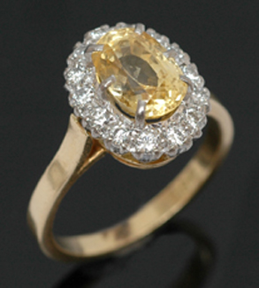 Appraisal: A sapphire and diamond cluster ring The central oval yellow