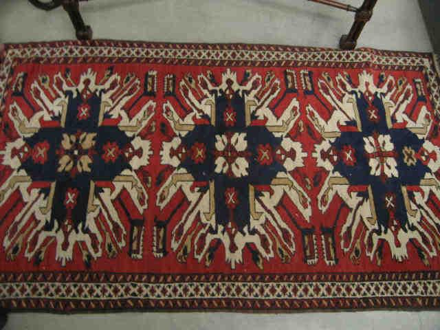 Appraisal: Heriz Persian Handmade Rug fine geometrics primarily reds blues ivory