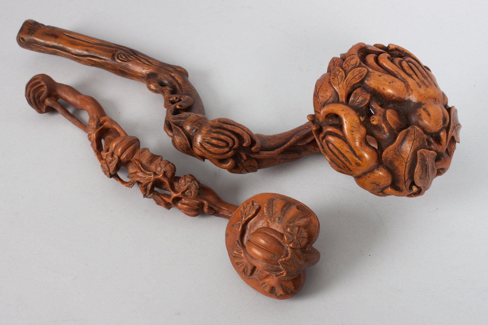 Appraisal: Two Chinese carved boxwood ruyi with carved foliate plant decoration