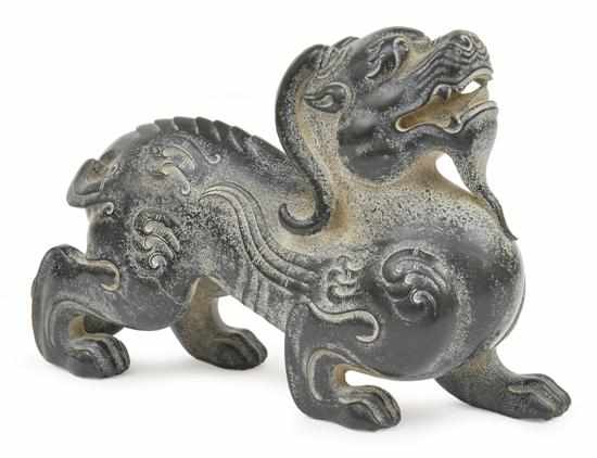 Appraisal: A CHINESE CARVED BLACK JADE DRAGON Carved in a crouching