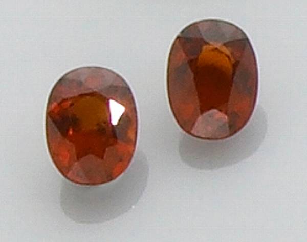 Appraisal: Pair of Mandarin Garnets Nigeria Possessing a sought-after deeply saturated