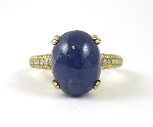 Appraisal: TANZANITE AND FOURTEEN KARAT GOLD RING with round-cut diamonds set