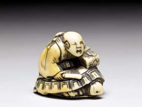 Appraisal: ANTIQUE IVORY NETSUKE Antique carved ivory netsuke with the legend