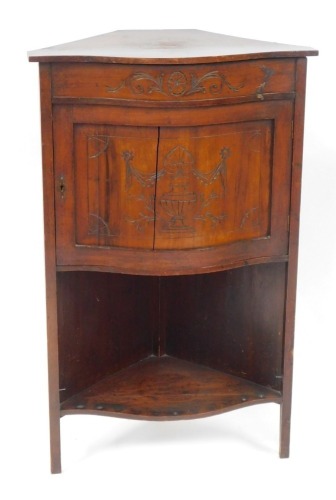 Appraisal: An Edwardian walnut corner cabinet with a bow front with