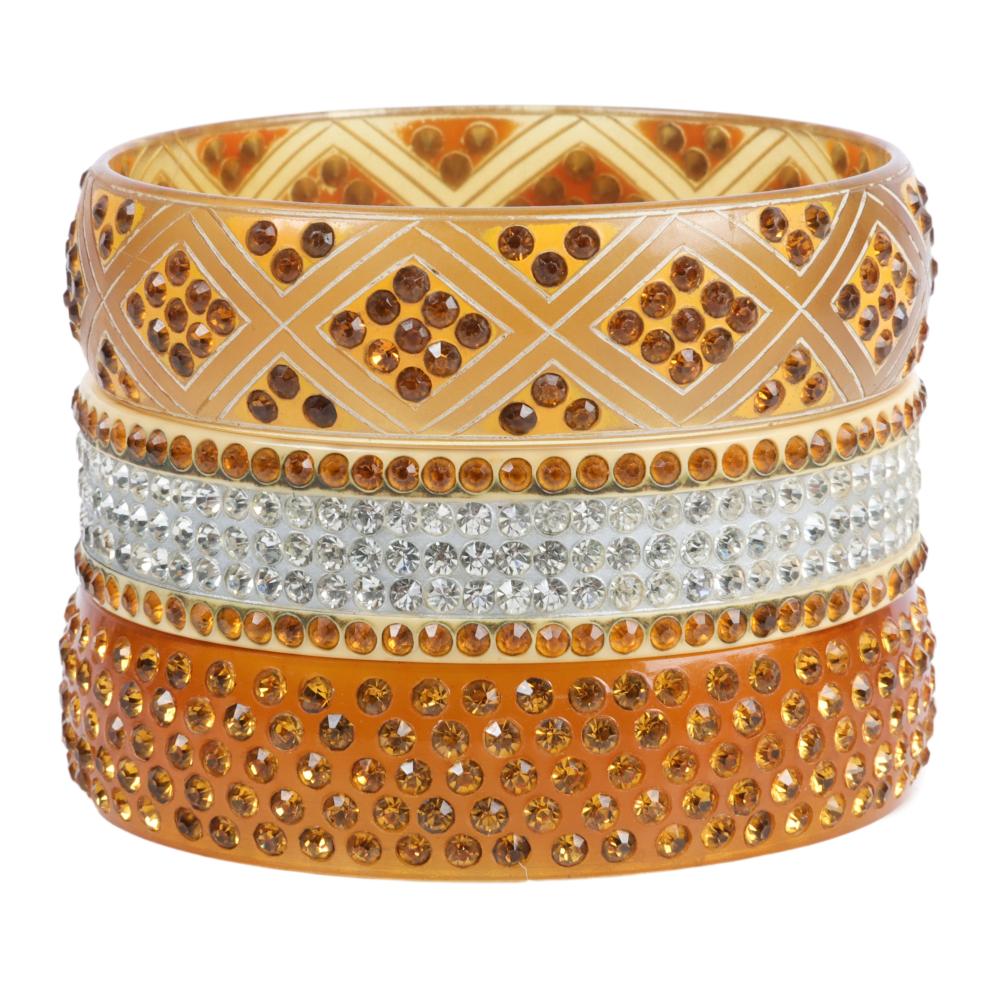 Appraisal: THREE APPLE JUICE AND CREAM CELLULOID SPARKLER BANGLE BRACELETS DINNER