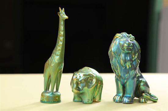 Appraisal: THREE ZSOLNAY ANIMAL FIGURES All green iridescent A giraffe h