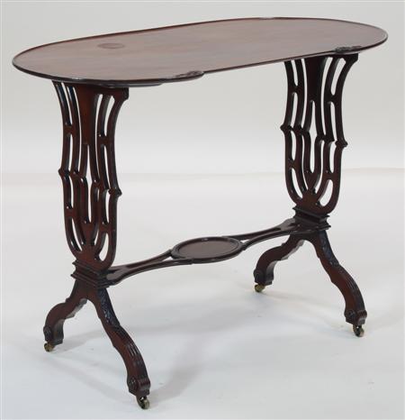 Appraisal: A Victorian style mahogany kidney shaped occasional table the tray