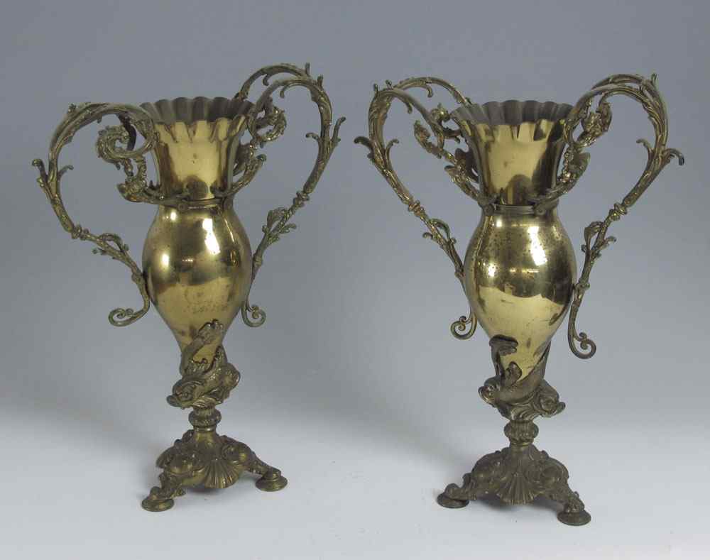 Appraisal: PAIR BRADLEY HUBBARD URNS Ornate metal urns dolphin supports scroll