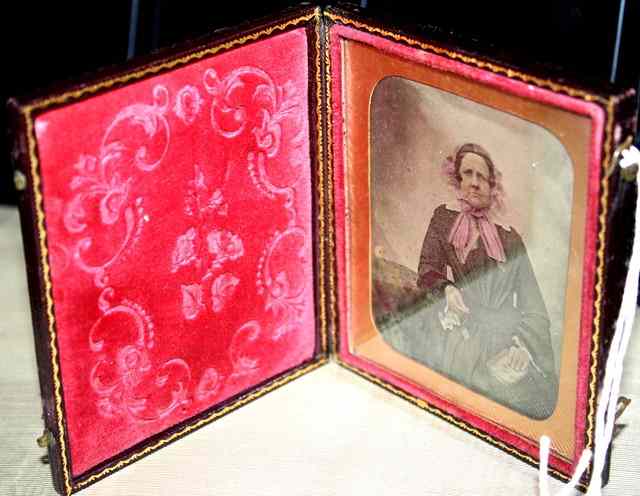 Appraisal: A VICTORIAN DAGUERREOTYPE of a seated lady wearing a pink