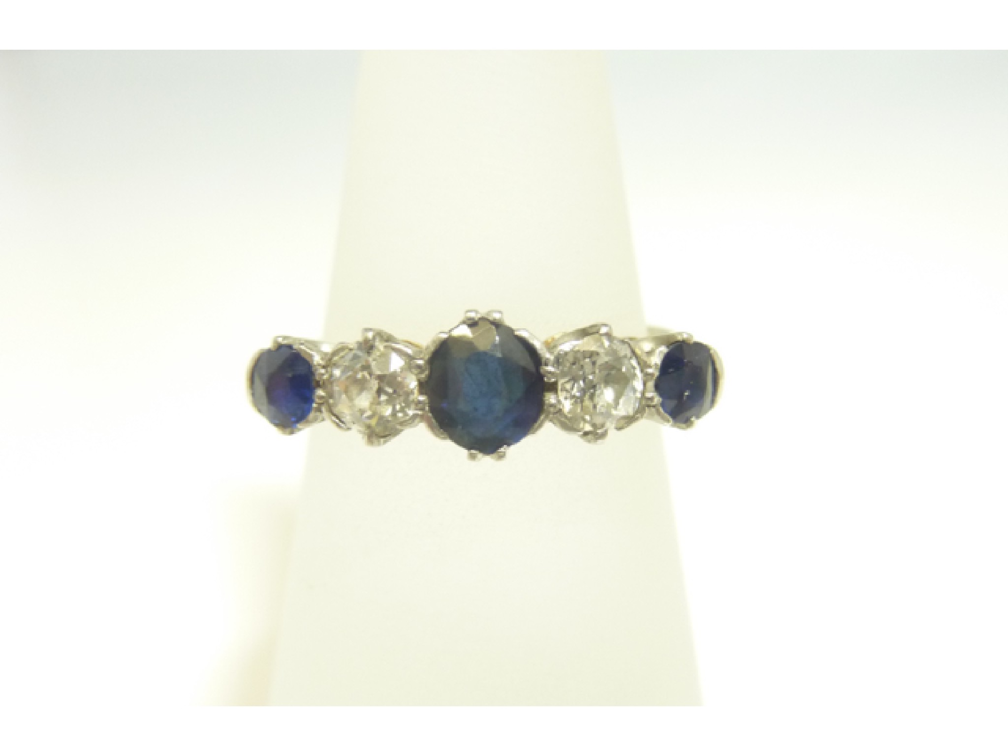 Appraisal: A sapphire and diamond ring centred with an oval mixed-cut