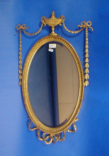 Appraisal: An Edwardian oval wall mirror with gilt neo-classical framework high