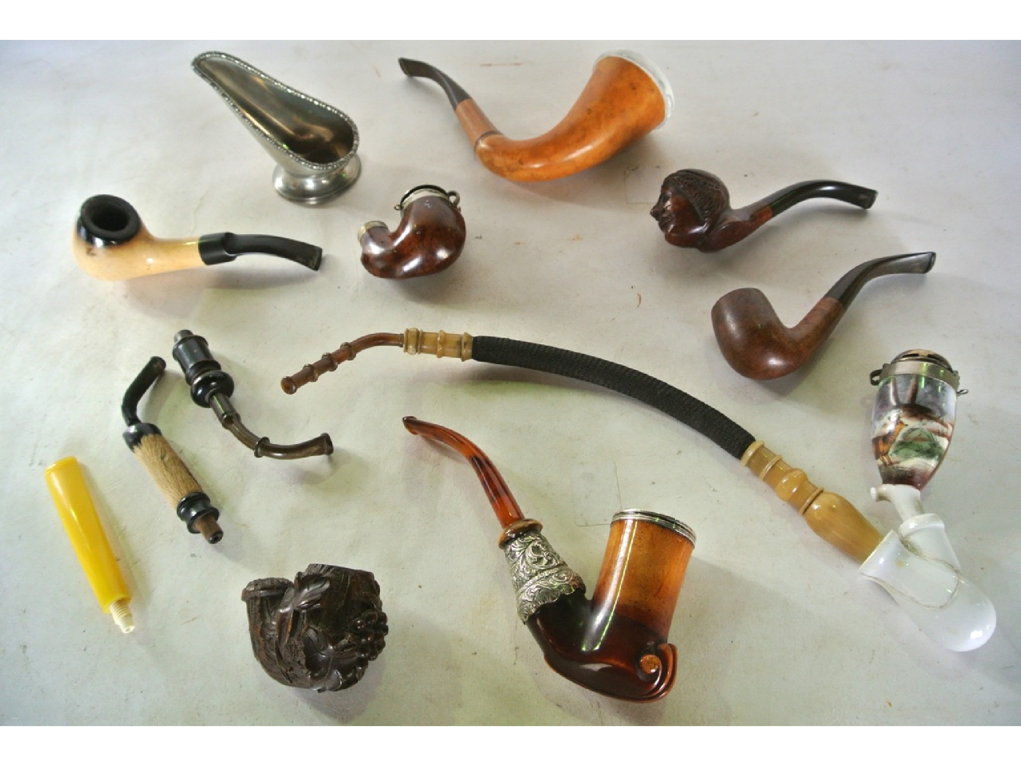 Appraisal: A selection of various antique tobacco pipes to include a