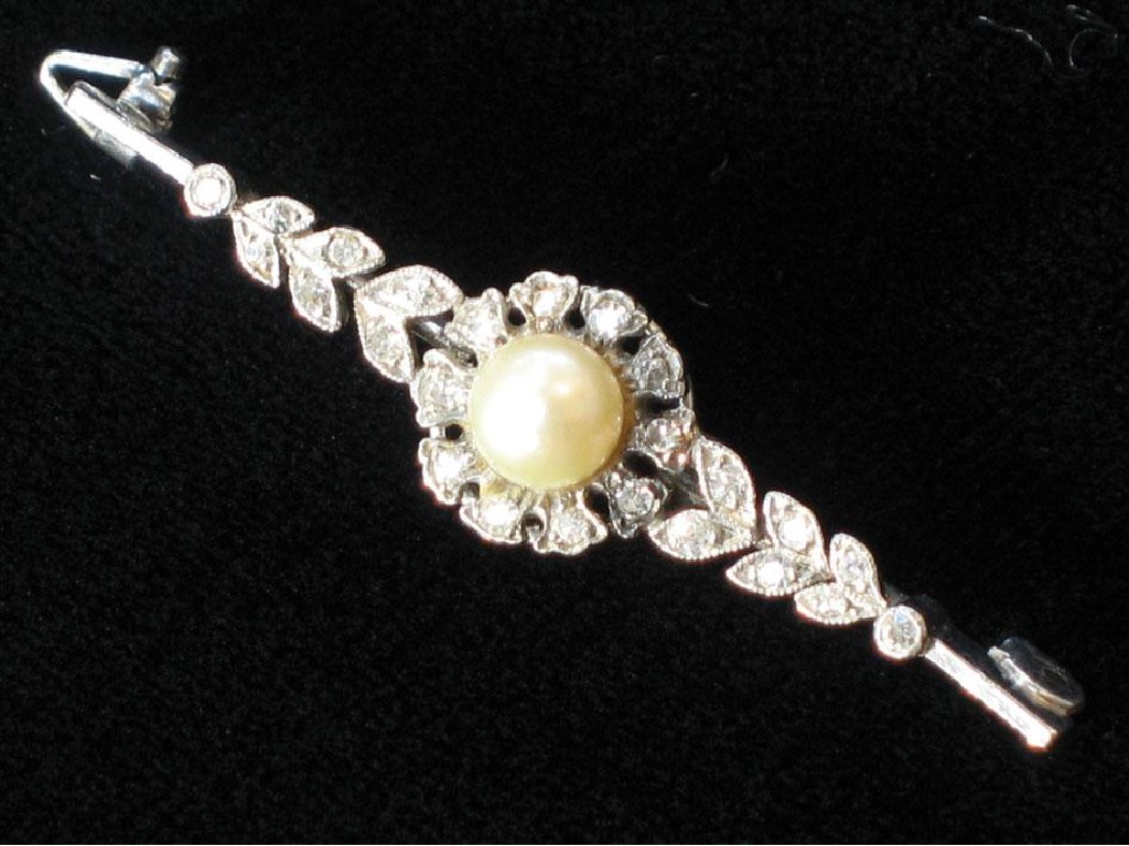 Appraisal: AN EDWARDIAN PEARL AND DIAMOND BROOCH with a central pearl