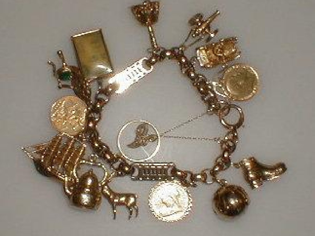 Appraisal: A heavy belcher charm bracelet with fourteen charms attached including