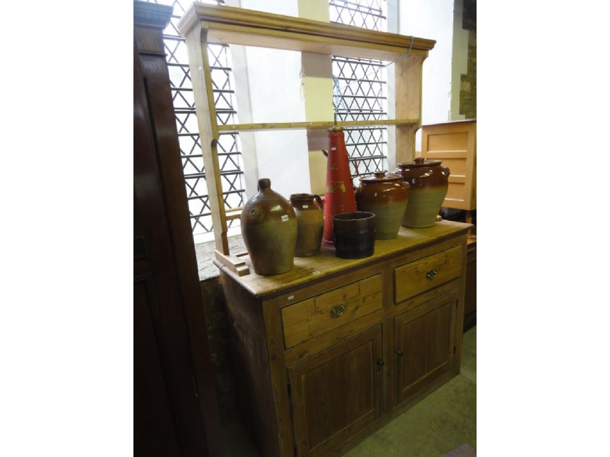 Appraisal: A stripped pine kitchen dresser the base enclosed by a