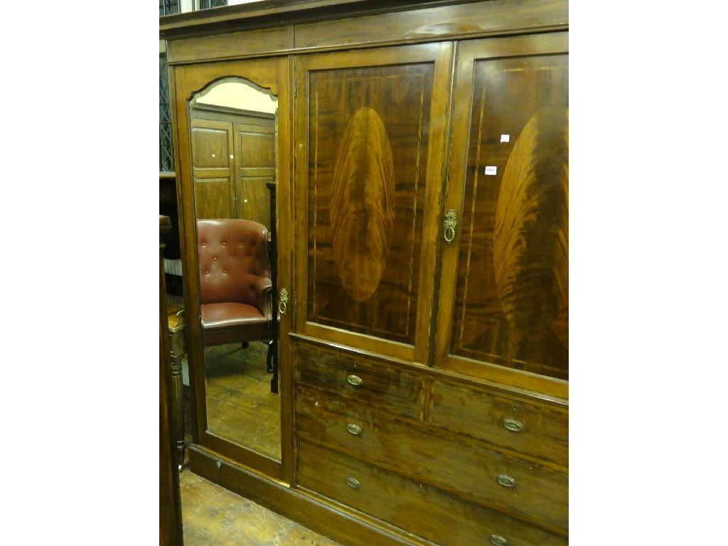 Appraisal: An Edwardian mahogany sectional wardrobe fitted with two long and