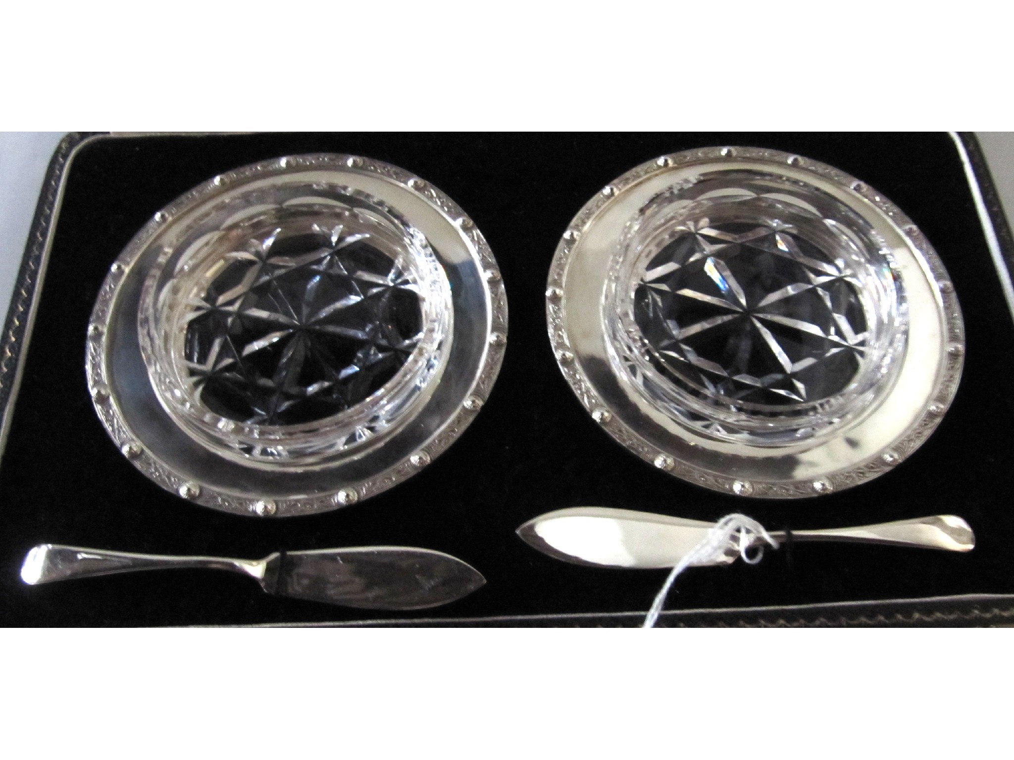 Appraisal: A cased pair of butter dishes in silver frames Birmingham