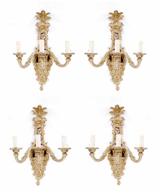 Appraisal: Continental gilt-metal three-light sconce set scrolling backplate terminating in masque