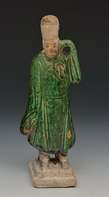 Appraisal: A CHINESE TERRACOTTA AND GREEN GLAZE TOMB FIGURE in the