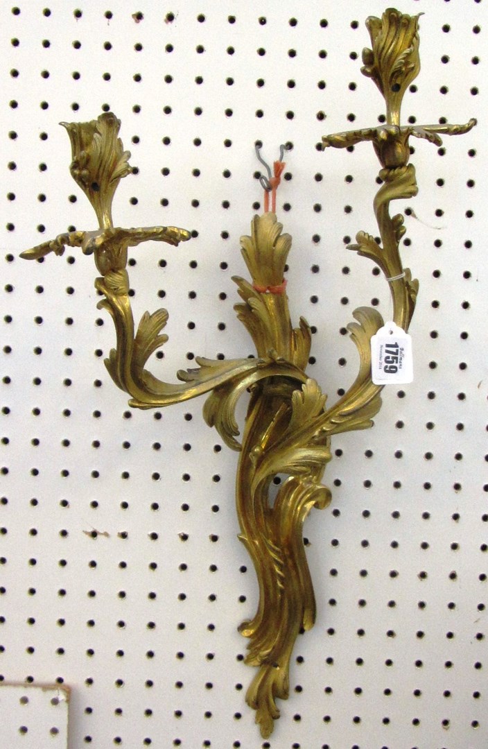 Appraisal: A pair of French twin light ormolu wall appliques of