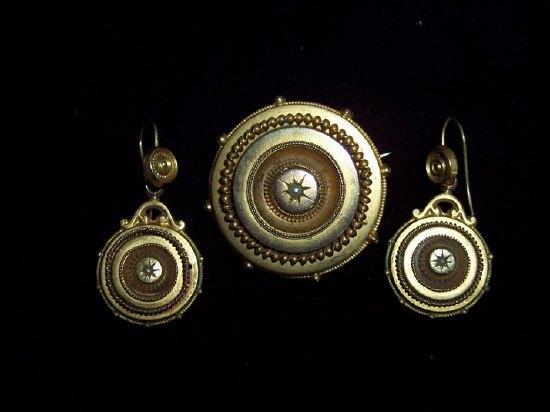 Appraisal: A Victorian gold target type brooch with half pearl set