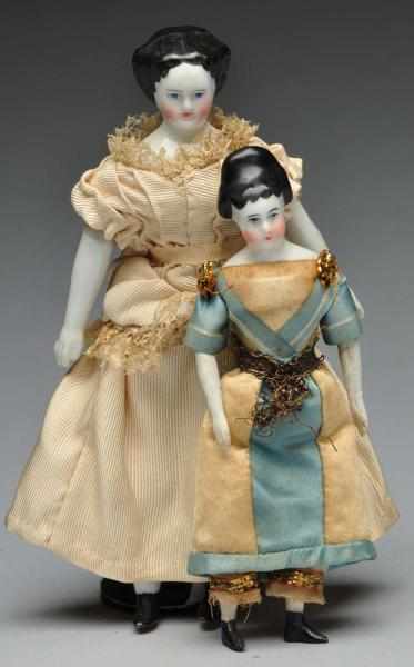 Appraisal: Pair of Doll House Dolls Description German china shoulder head