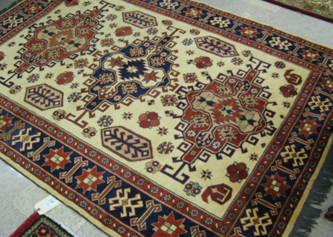 Appraisal: HAND KNOTTED ORIENTAL CARPET Persian tribal design of three geometric