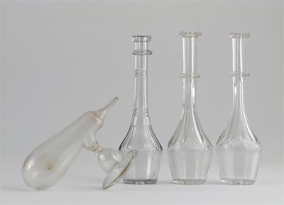 Appraisal: A glass milk expresser and three toddy lifters with panel