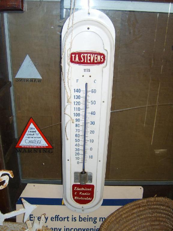 Appraisal: An outsized advertising thermometer for T A Stevens Electrical Radio