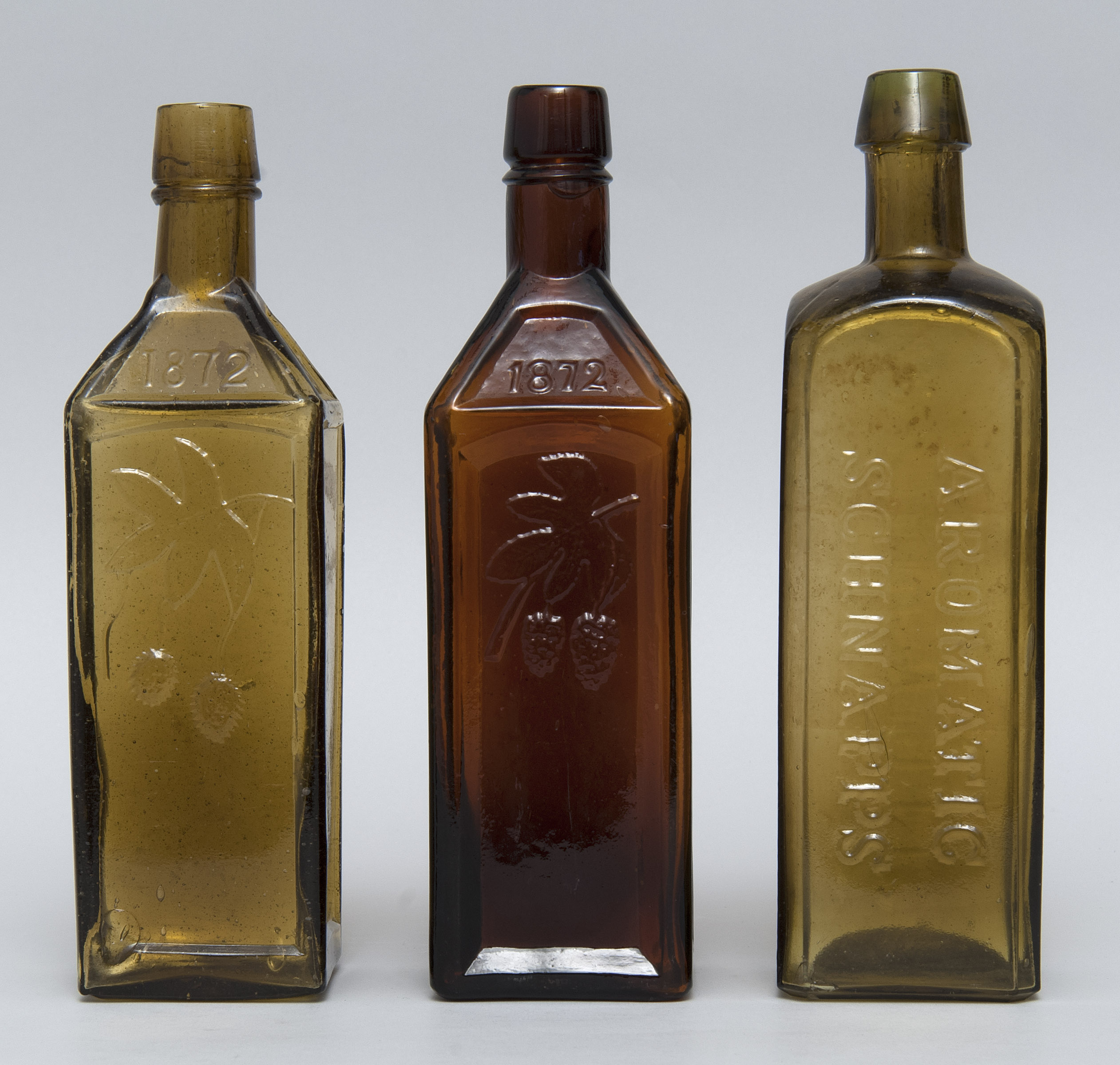 Appraisal: THREE GLASS LIQUOR BOTTLES th Century Dr Soule's bitters bottles