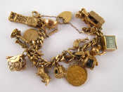 Appraisal: A carat gold charm bracelet with approx charms including a