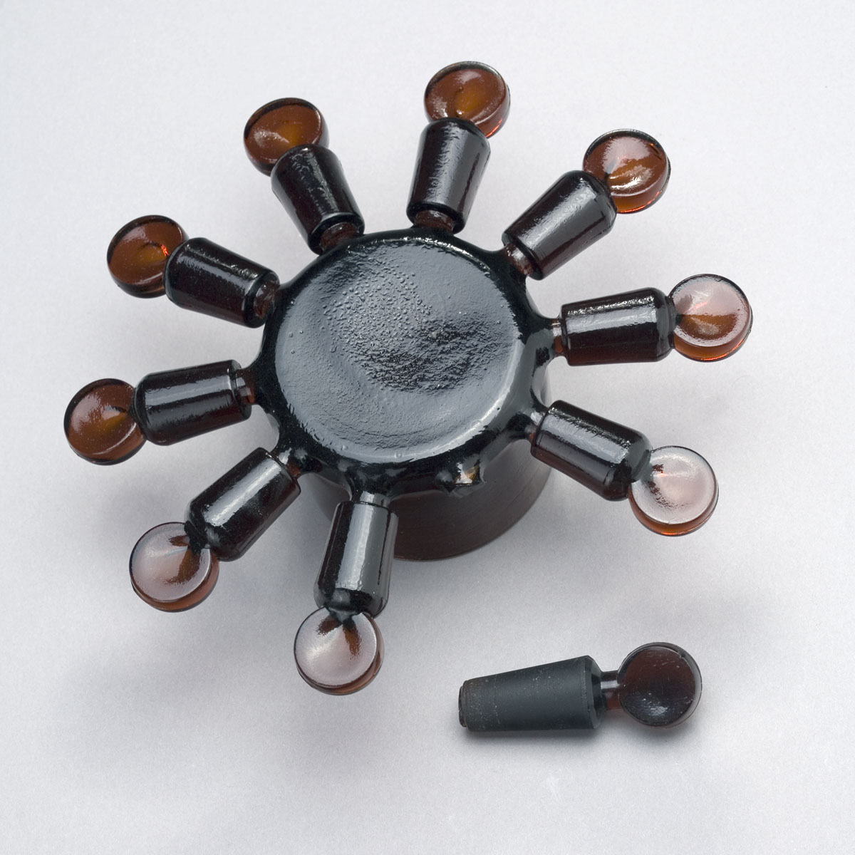 Appraisal: WHEEL OF DARK AMBER PRESSED FLAT-SIDED STOPPERS CIRCA - Together