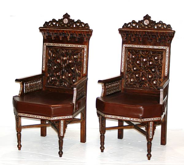 Appraisal: A pair of Moorish style inlaid hardwood leather upholstered armchairs