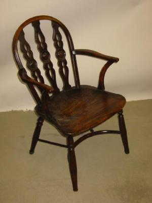 Appraisal: A YEW WOOD WINDSOR ARMCHAIR of hoop back form with