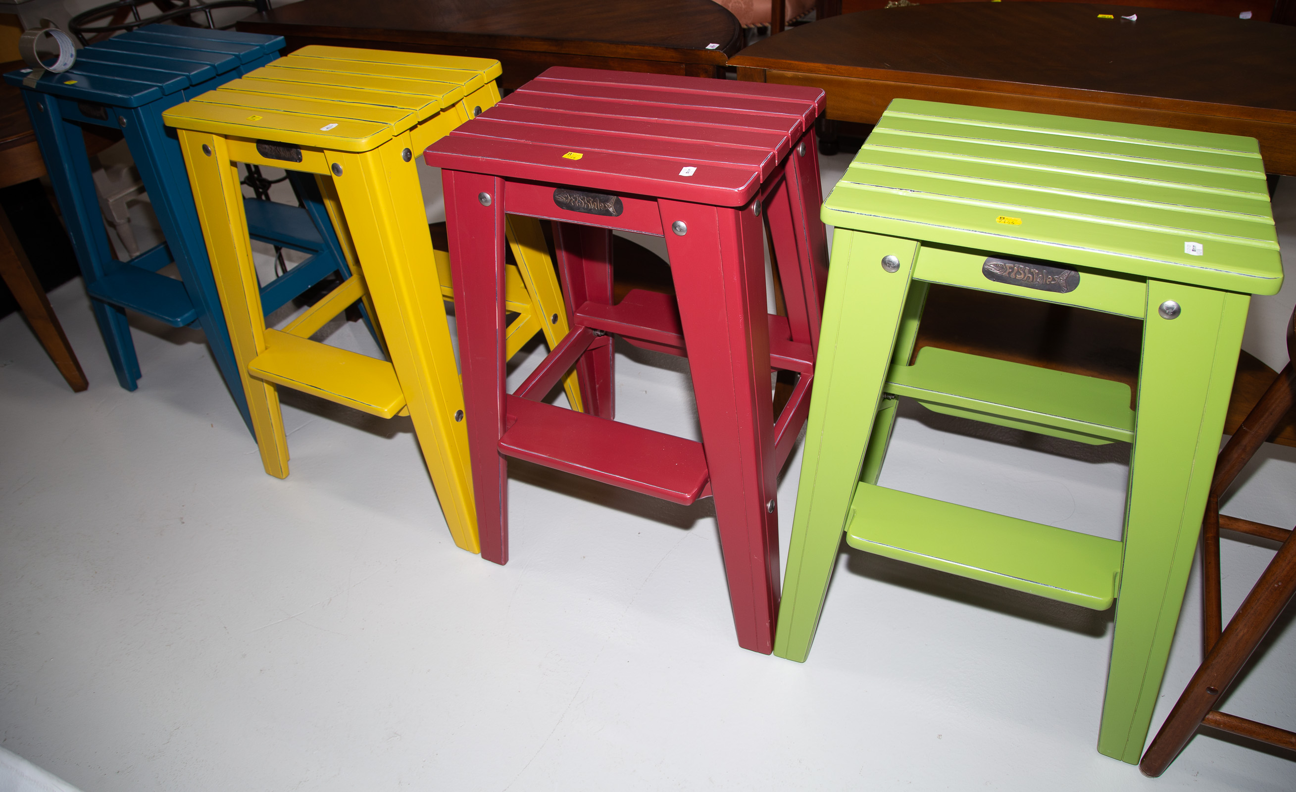 Appraisal: FOUR BRIGHT COLORED FISHTALES BAR STOOLS Blue yellow red and