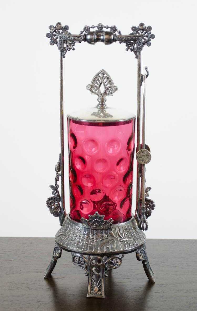 Appraisal: VICTORIAN PICKLE CASTER with ruby red coin spot patterned glass