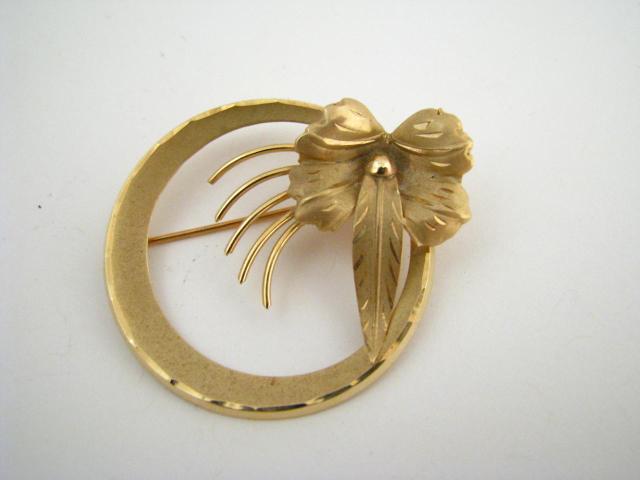 Appraisal: Lady's K yellow gold circle pin with flower motif brushed