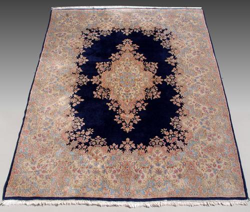 Appraisal: KIRMAN ORIENTAL RUG Persian Kirman open field dark blue center