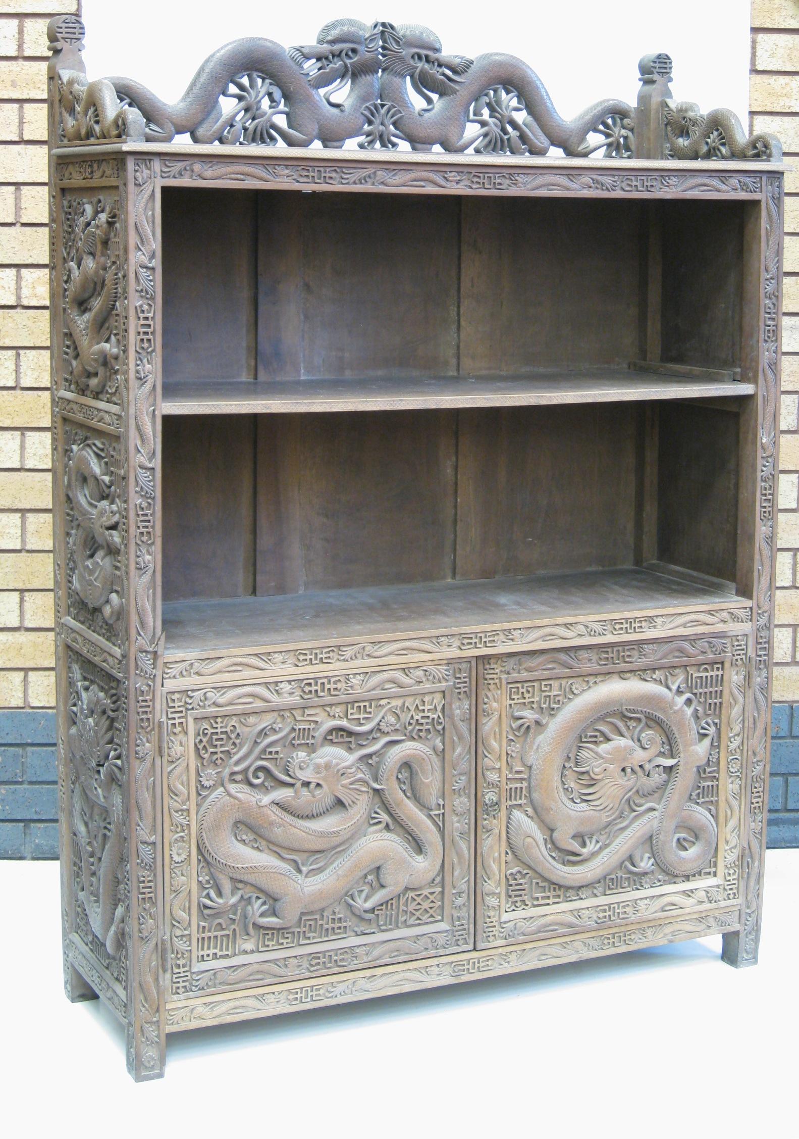 Appraisal: A Kashmir carved hardwood Cabinet with dragon carved frieze above