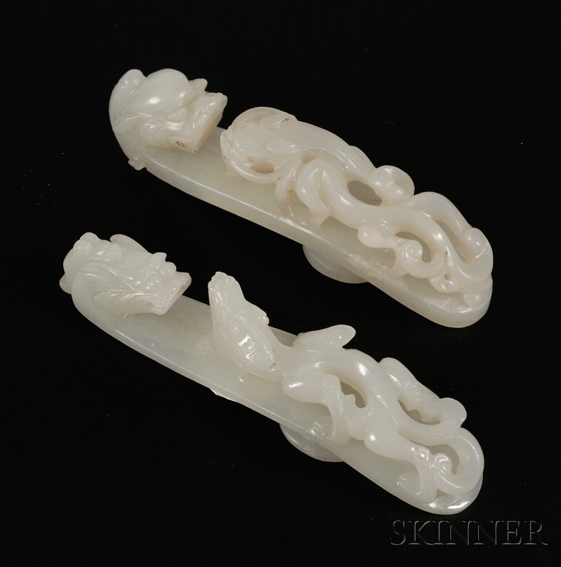 Appraisal: Two Jade Garment Hooks th century pale gray-green stone surface