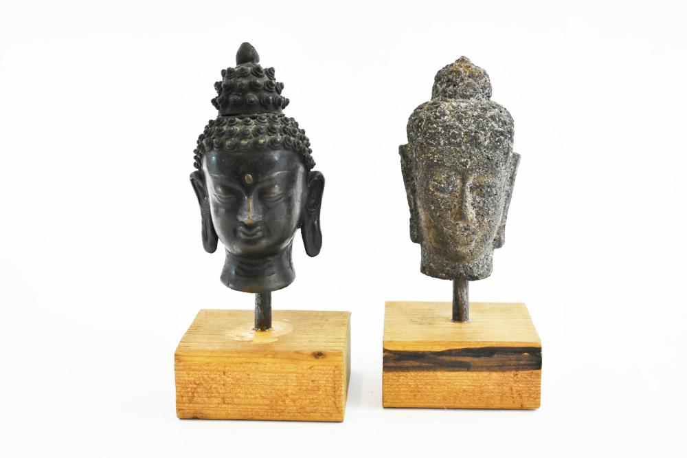 Appraisal: TWO SOUTHEAST ASIAN BUDDHA HEADSThe first a volcanic gray sandstone