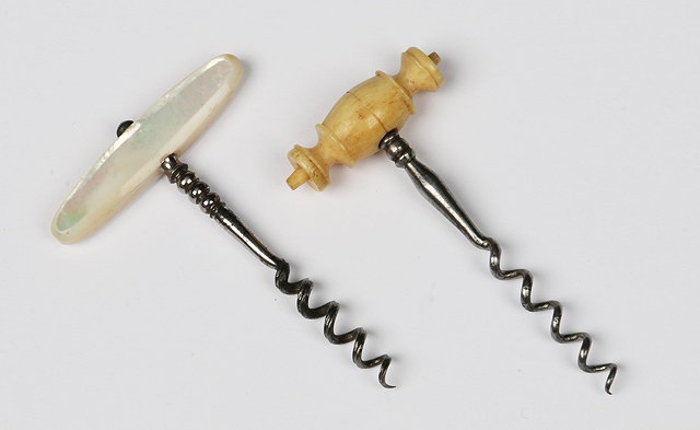 Appraisal: A MOTHER OF PEARL HANDLED PERFUME CORKSCREW with split helix